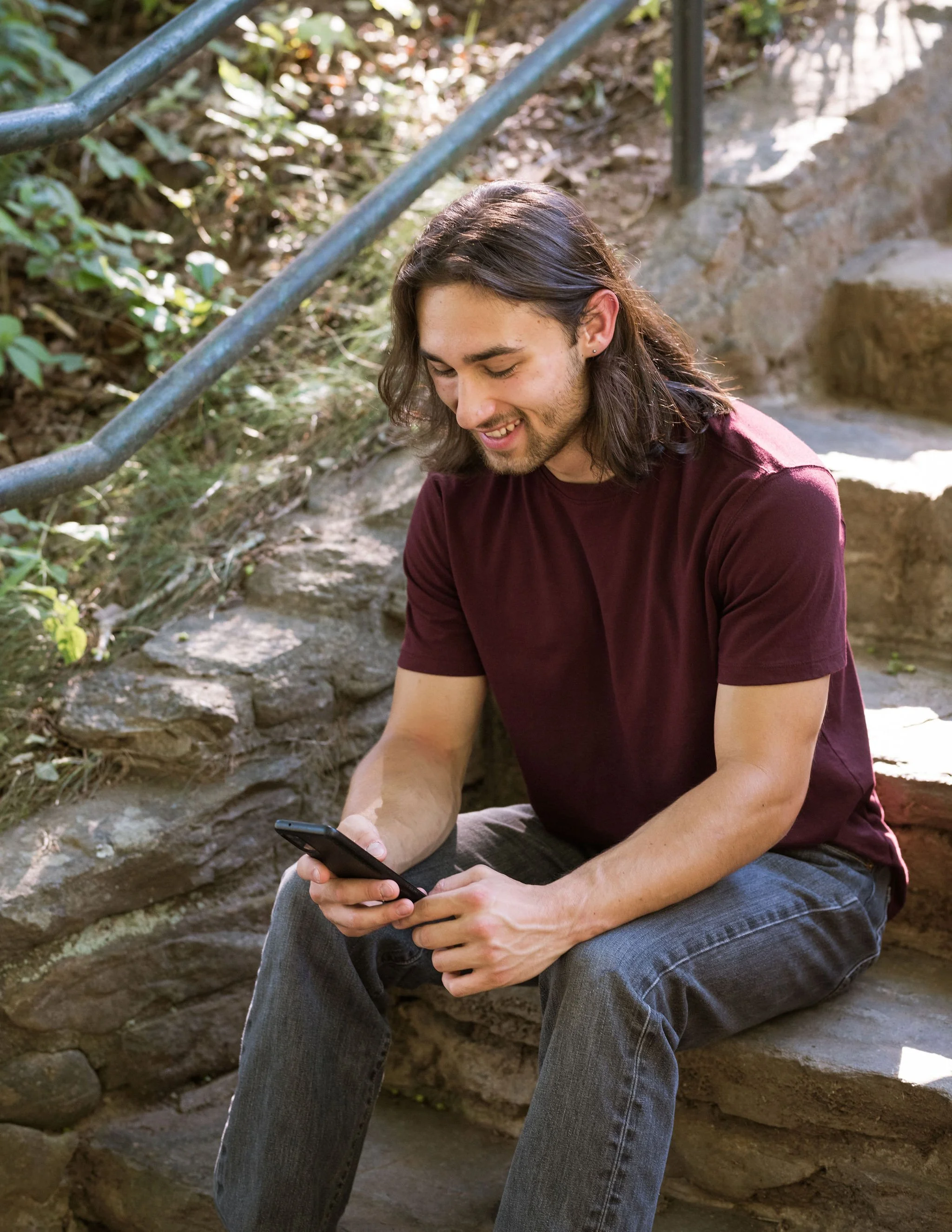 Happy College Student Sitting on Campus Stairs