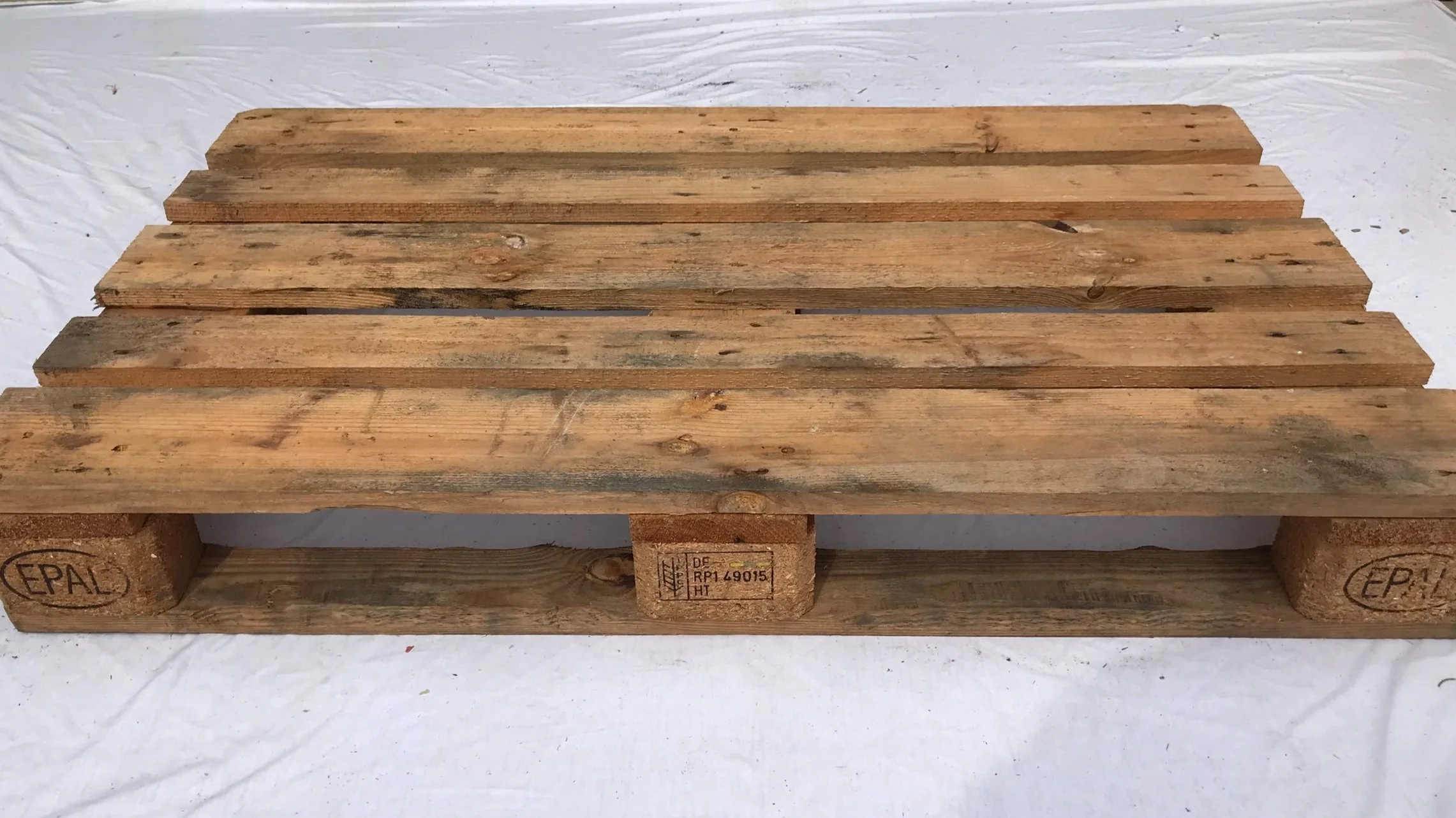Recycled hardwood EURO pallet 1200 milimeters by 800 milimeters on a white background. BEST Savannah area wood pallet distributor, BEST in the Southeast.