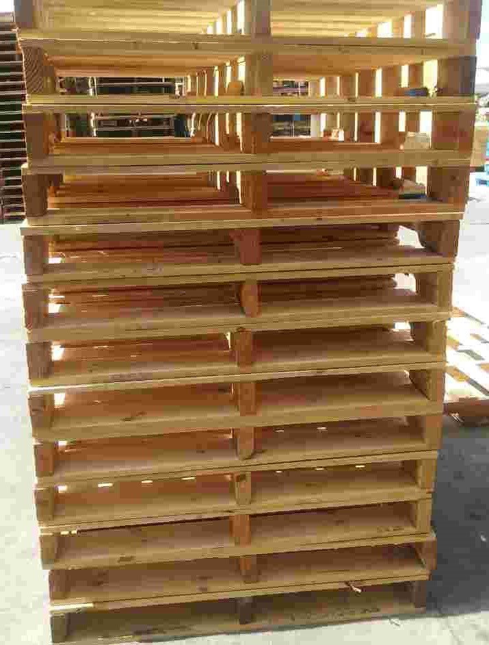 Stacked wooden pallets in a warehouse setting
