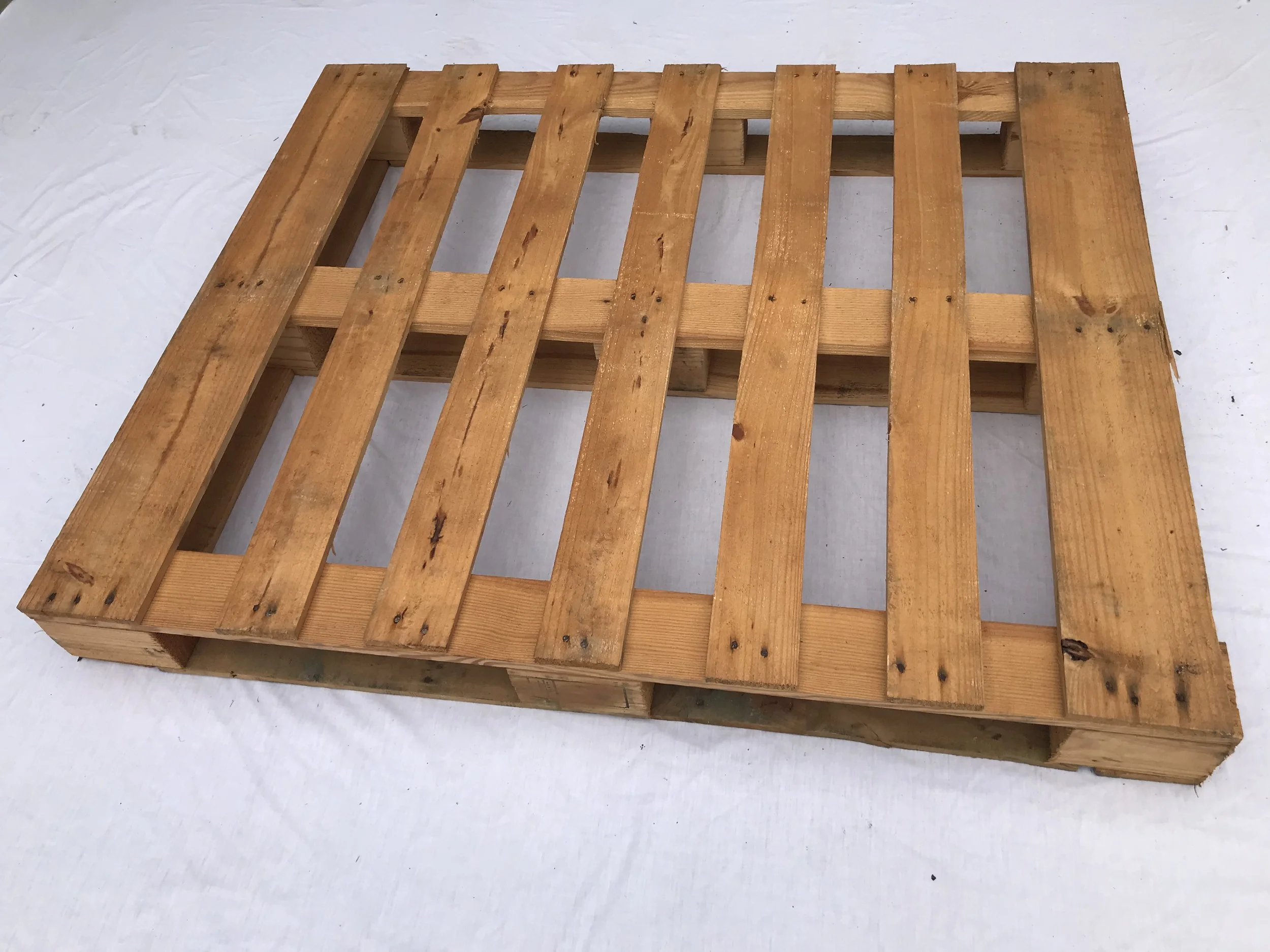 New hardwood Export pallet 1200 milimeters by 1000 milimeters on a white background. BEST Savannah area wood pallet distributor, BEST in the Southeast.