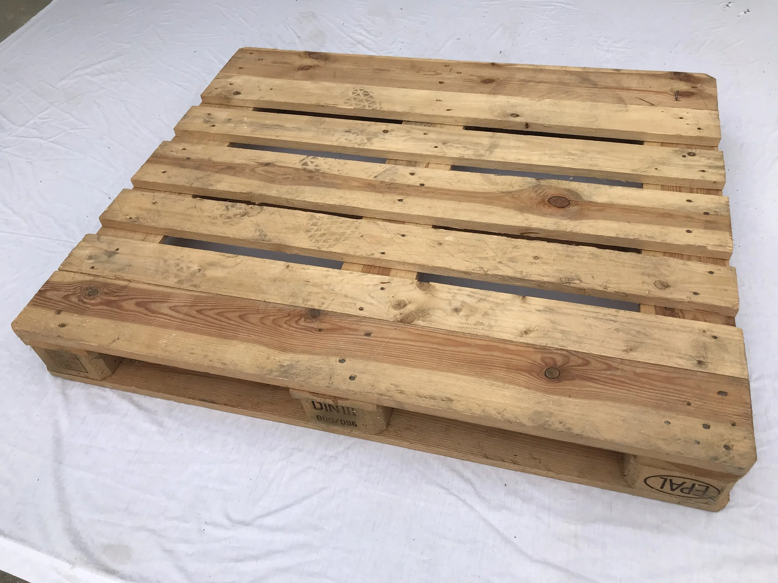 New hardwood EURO pallet 1200 milimeters by 1000 milimeters on a white background. BEST Savannah area wood pallet distributor, BEST in the Southeast.