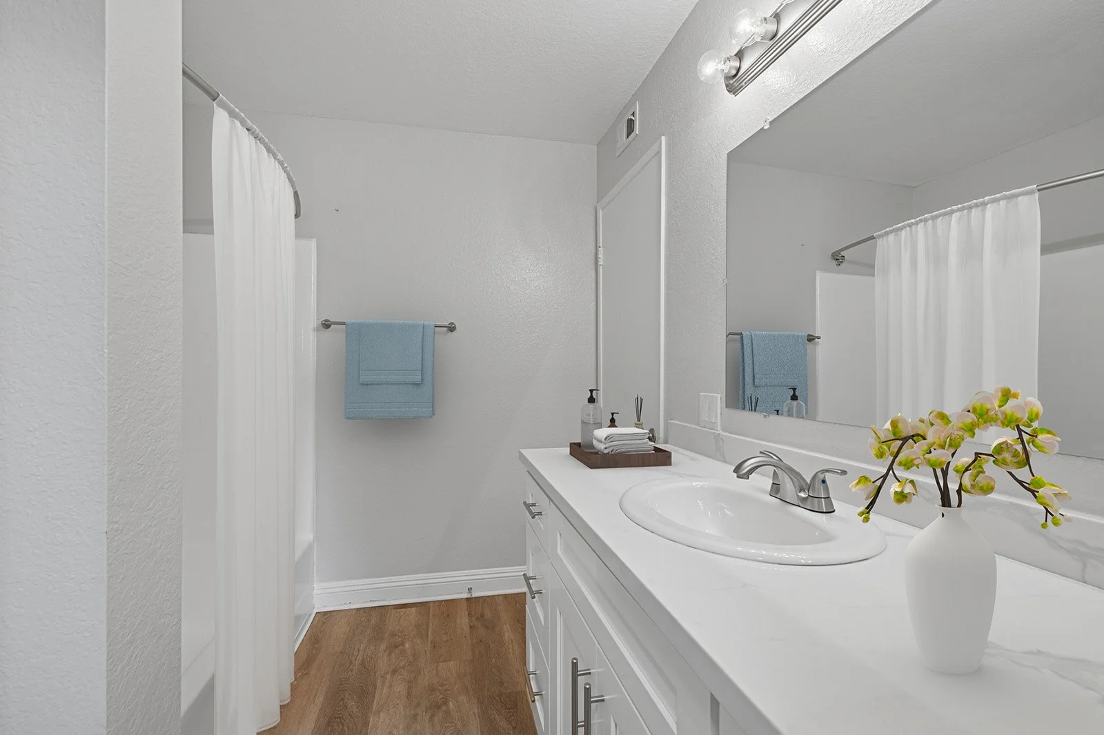 An image of our second bathroom in the Two-Bedroom, Two-Bathroom Unit, styled with bathroom accessories. 