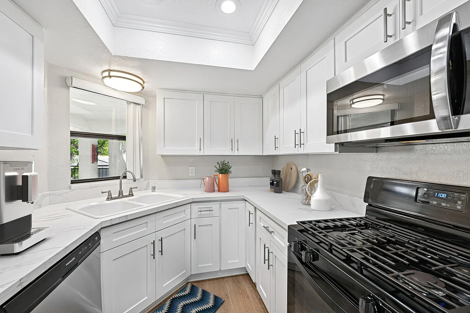 An image of our spacious kitchen in the  Two-Bedroom, Two-Bathroom Unit, shown with Furniture. 