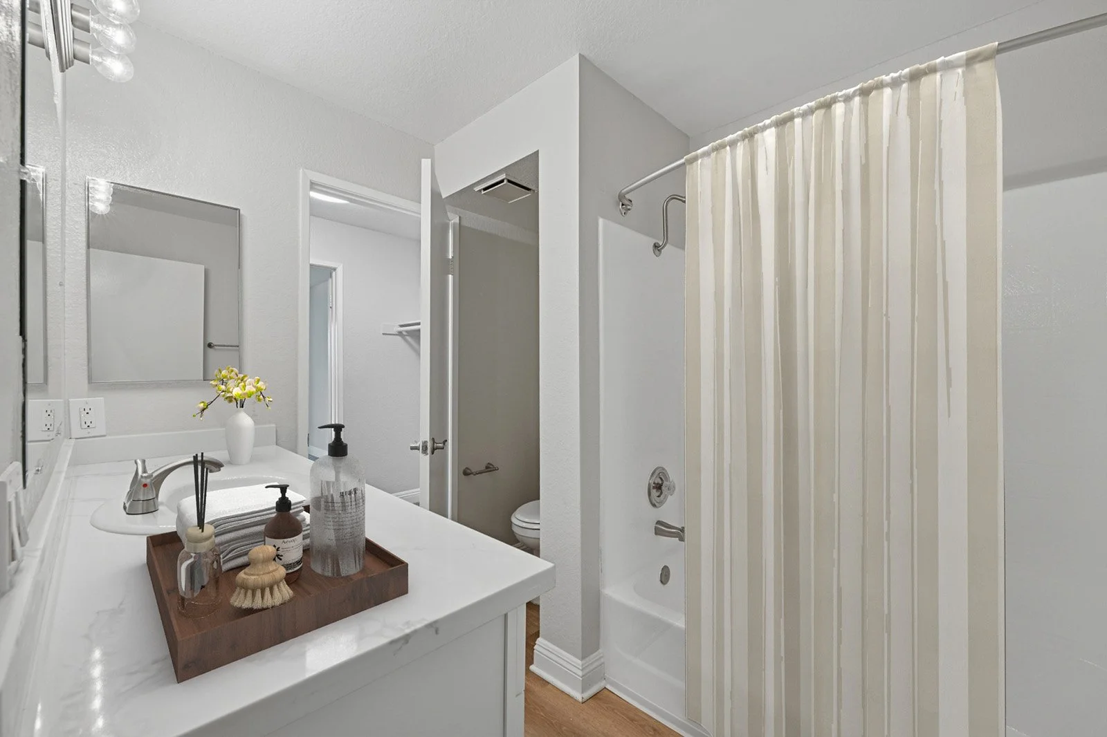 An image of our primary bathroom in the Two-Bedroom, Two-Bathroom Unit, shown with bathroom accesories. 
