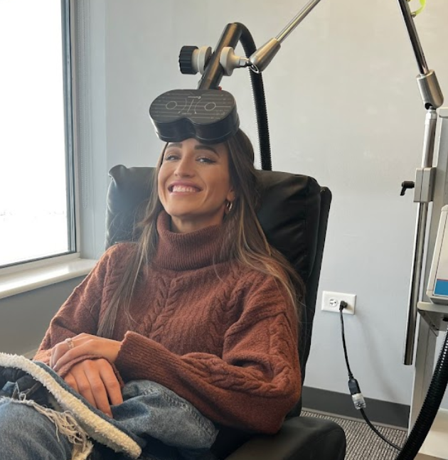 A woman receives rTMS therapy