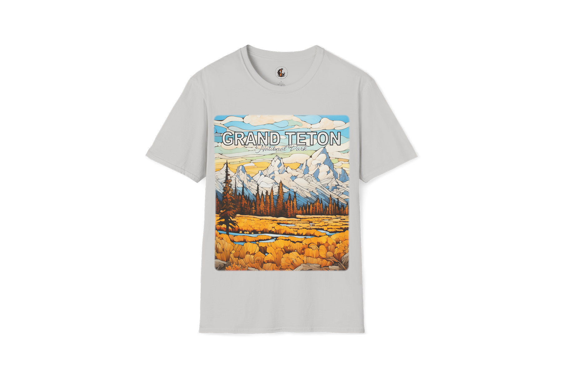 Light gray Grand Teton graphic T-shirt featuring a mountain landscape with golden meadow, pine trees, blue sky, and snowy peaks.