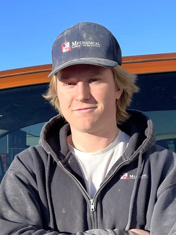 Illustration of a person in a blue cap and shirt with a company logo, no facial features visible.