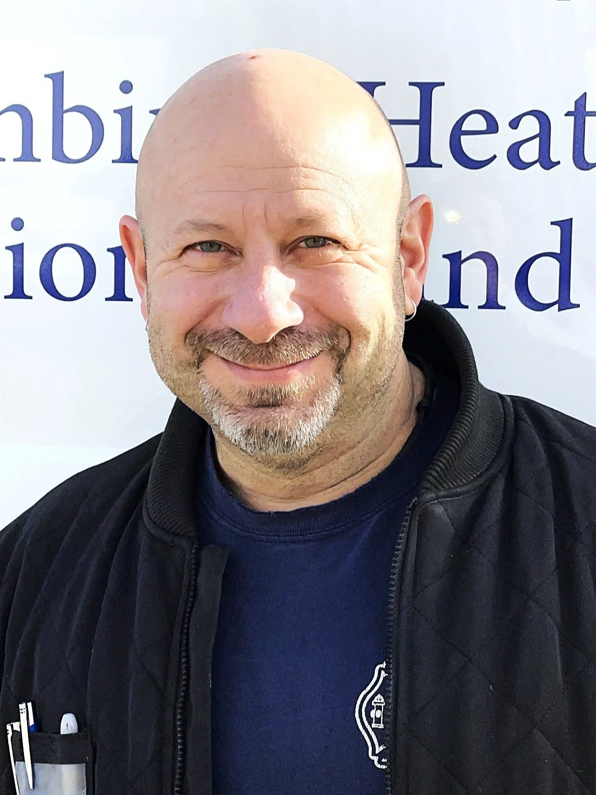 Illustration of a person wearing a baseball cap and a shirt with the mechanical company logo.