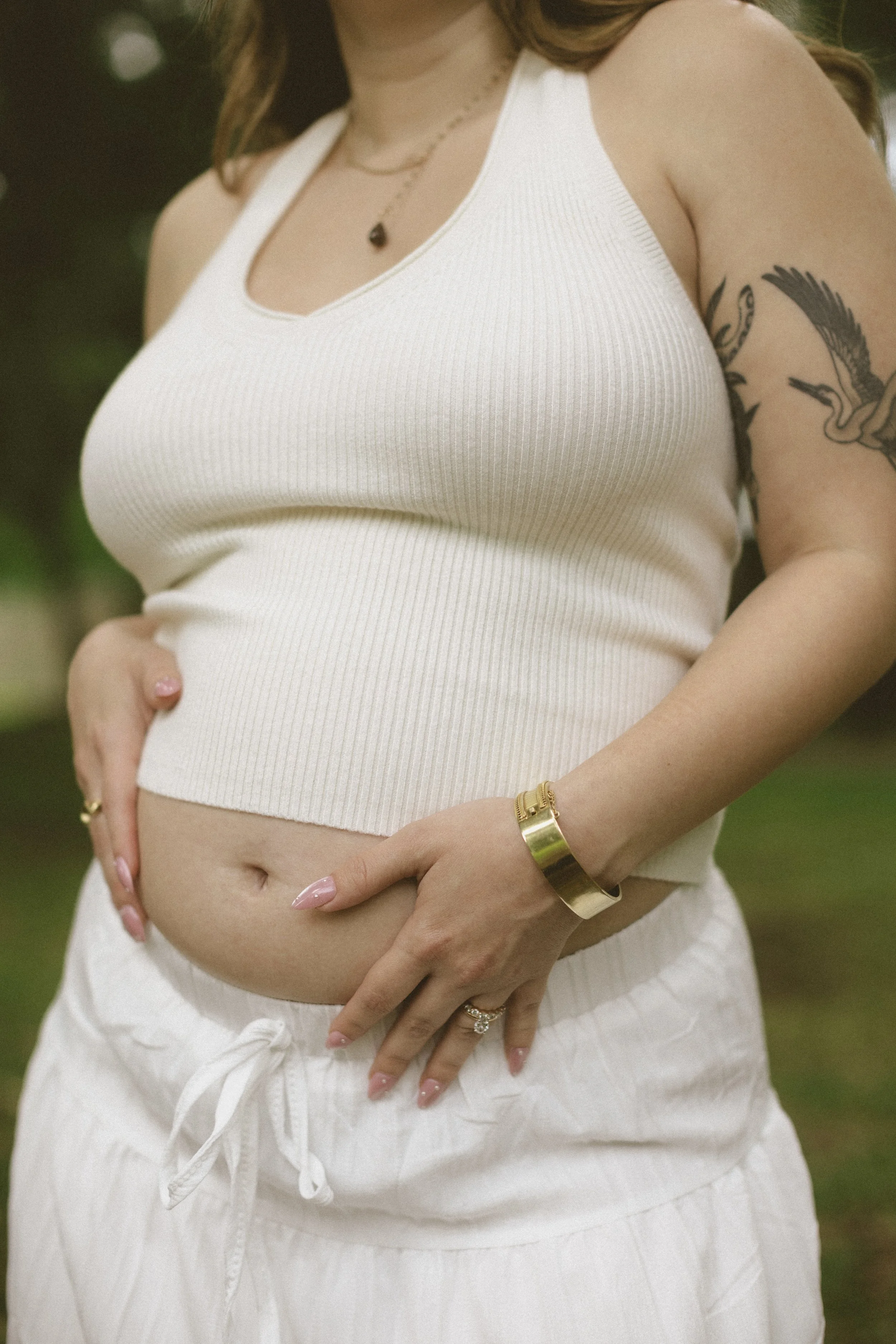 Close-up maternity portrait highlighting baby bump during a New Orleans motherhood session.