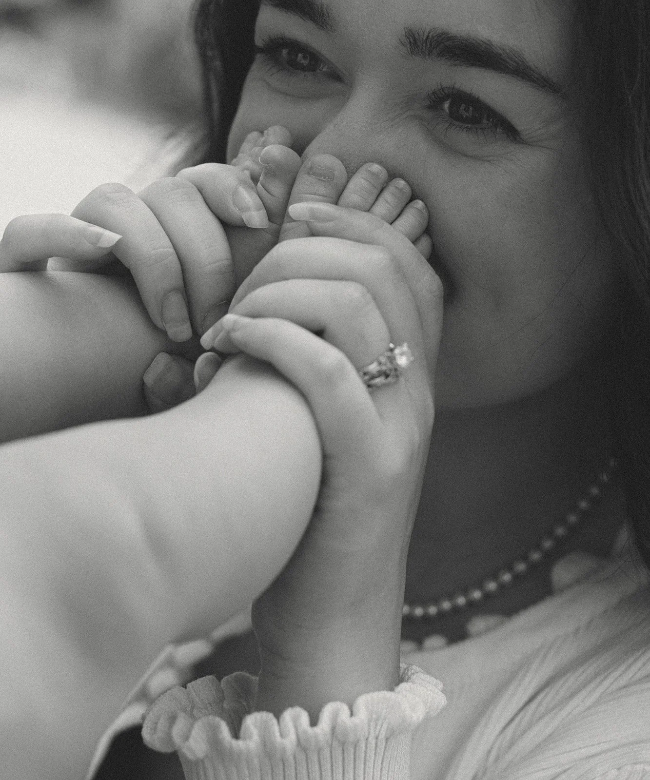 Mother and daughter photographed together in their nursery during an intimate New Orleans family session.