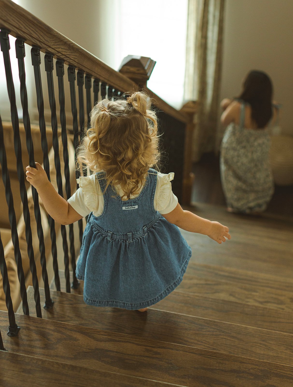 Candid family moment photographed in natural window light inside a Destrehan, Louisiana home.