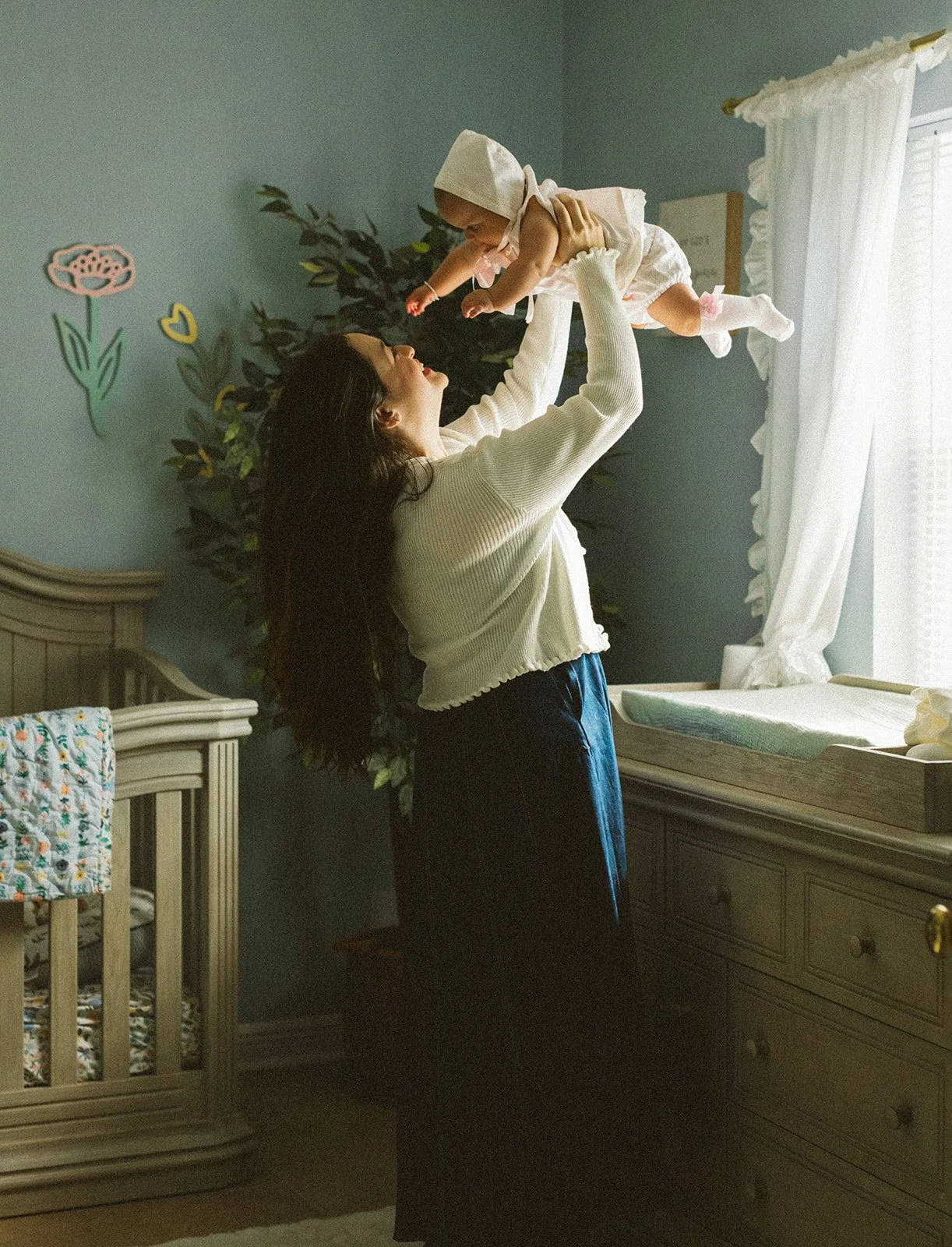 Baby sitting in soft window light during an at-home family photography session in New Orleans.
