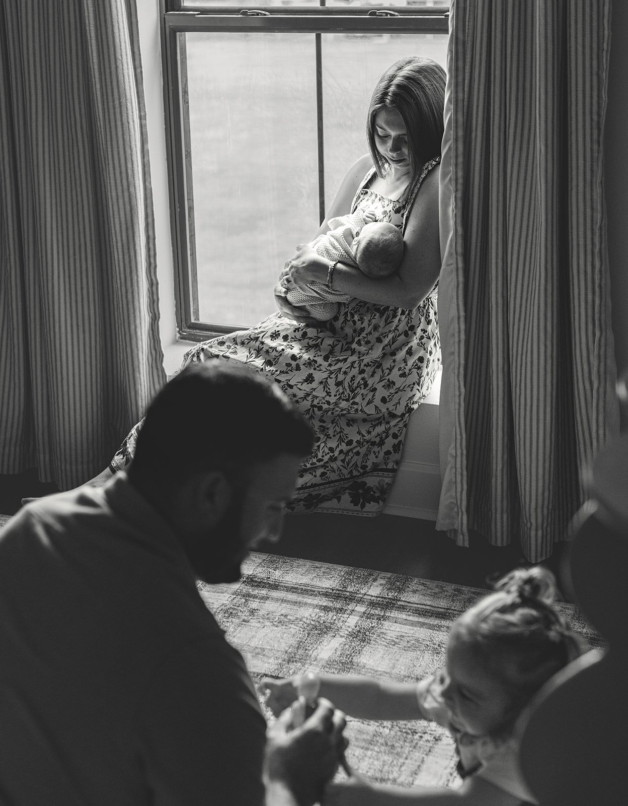 Parents laughing with their child during an intimate family photography session at their Destrehan home.