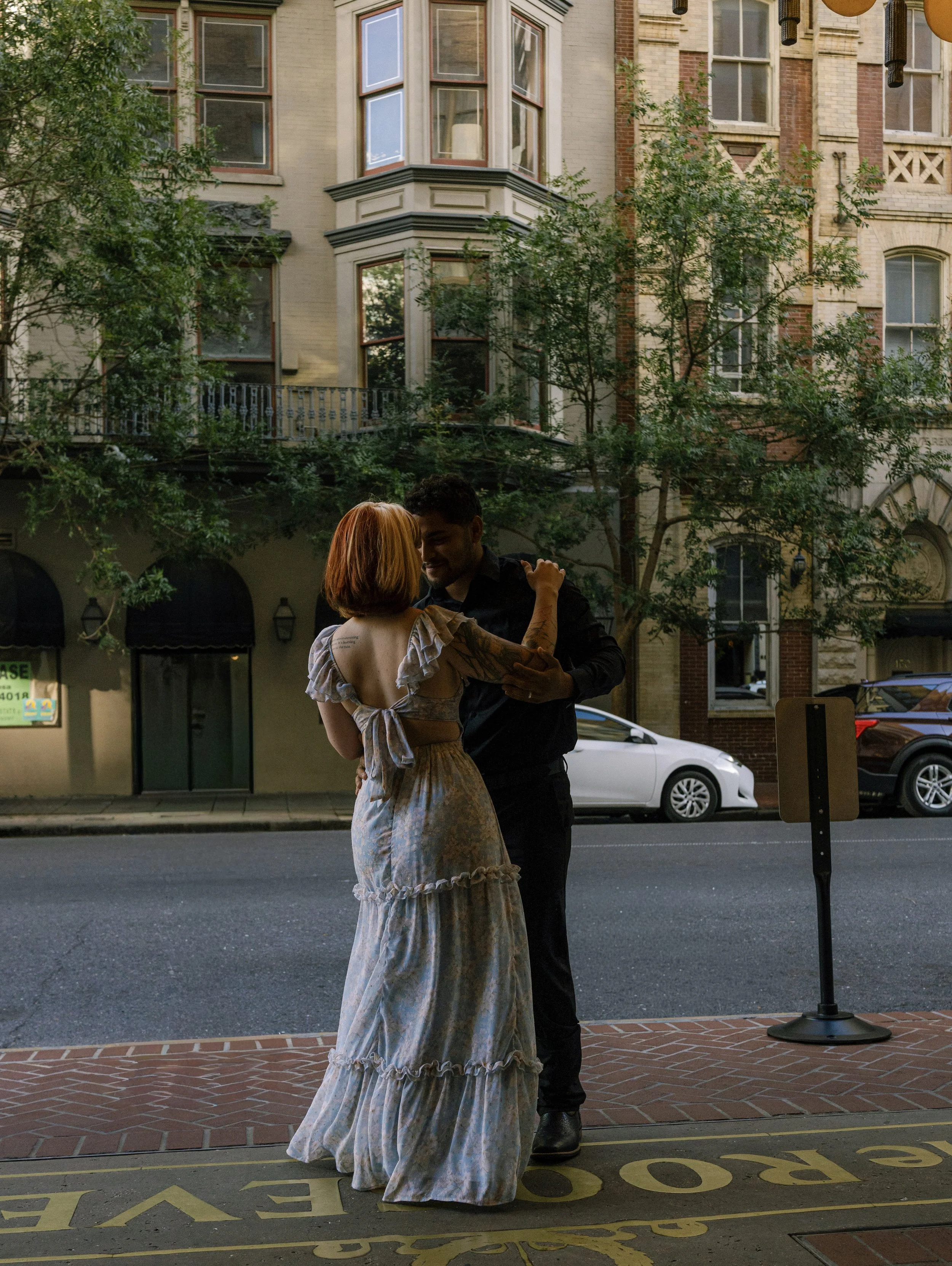 Couple embracing closely with the city of New Orleans behind them.