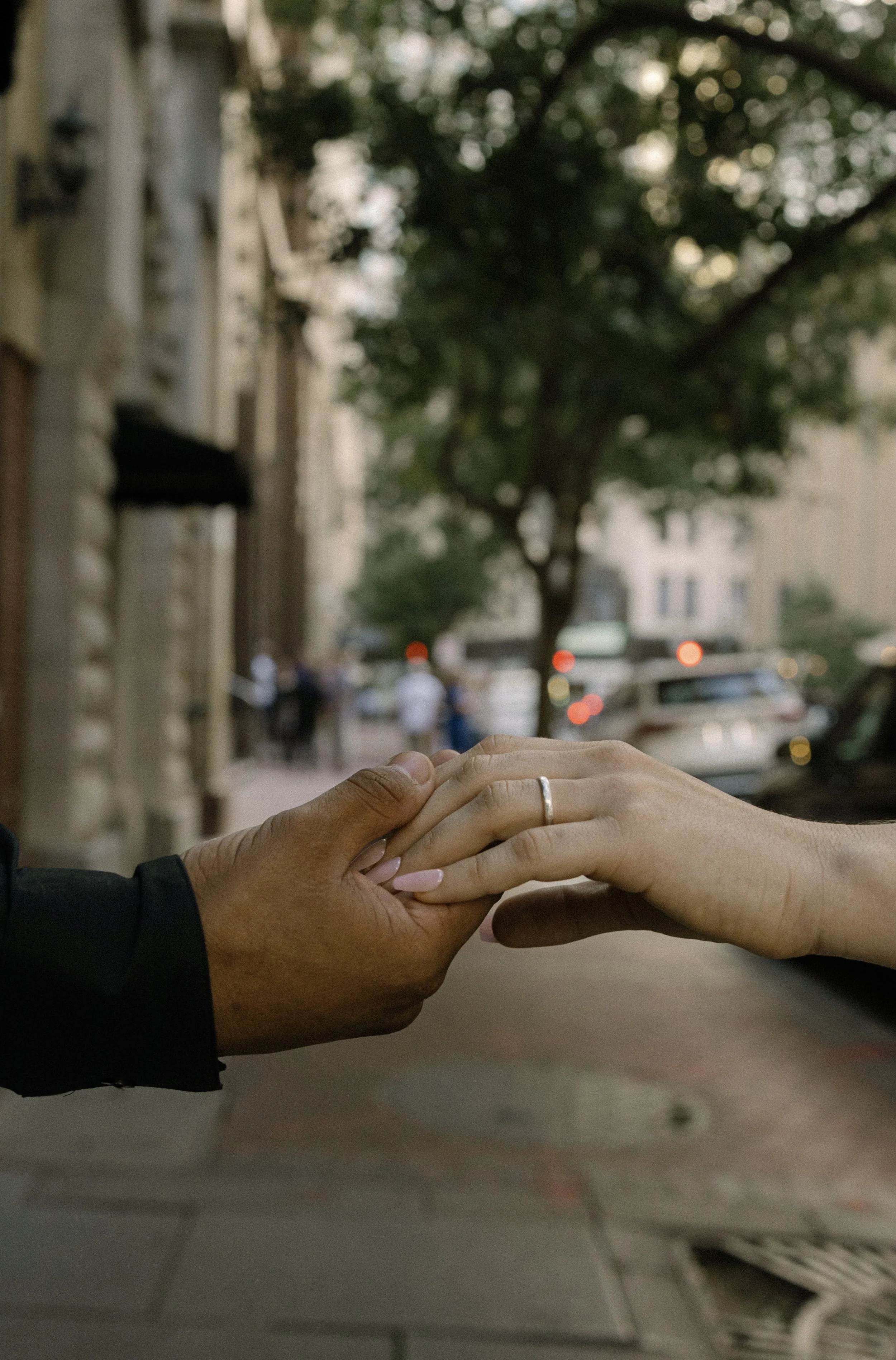 Couple holding hands through downtown new Orleans.
