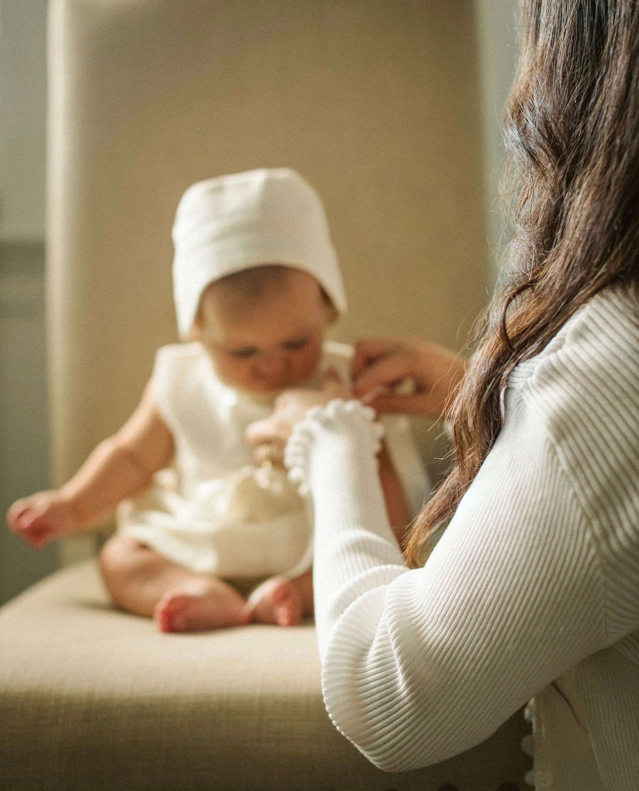 Quiet close-up of a baby resting beside her mother during a natural New Orleans family photography session.