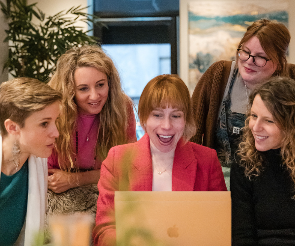 Susi Castle presenting marketing strategy fundamentals to a four-person marketing team in a workshop setting