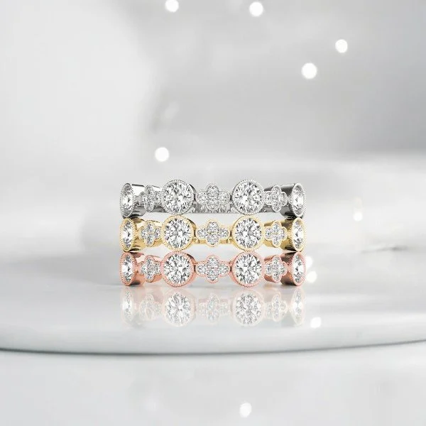 Three custom diamond bands in white, yellow and rose gold
