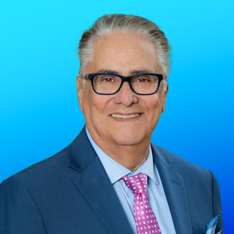 Mercy Mental Health- Smiling man in a blue suit and pink tie on a blue background