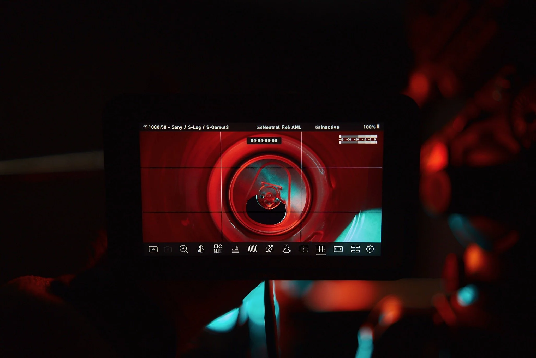 Camera screen showing an abstract red and blue swirl pattern, with various camera control icons at the bottom and settings on the top, used for filming or photography.