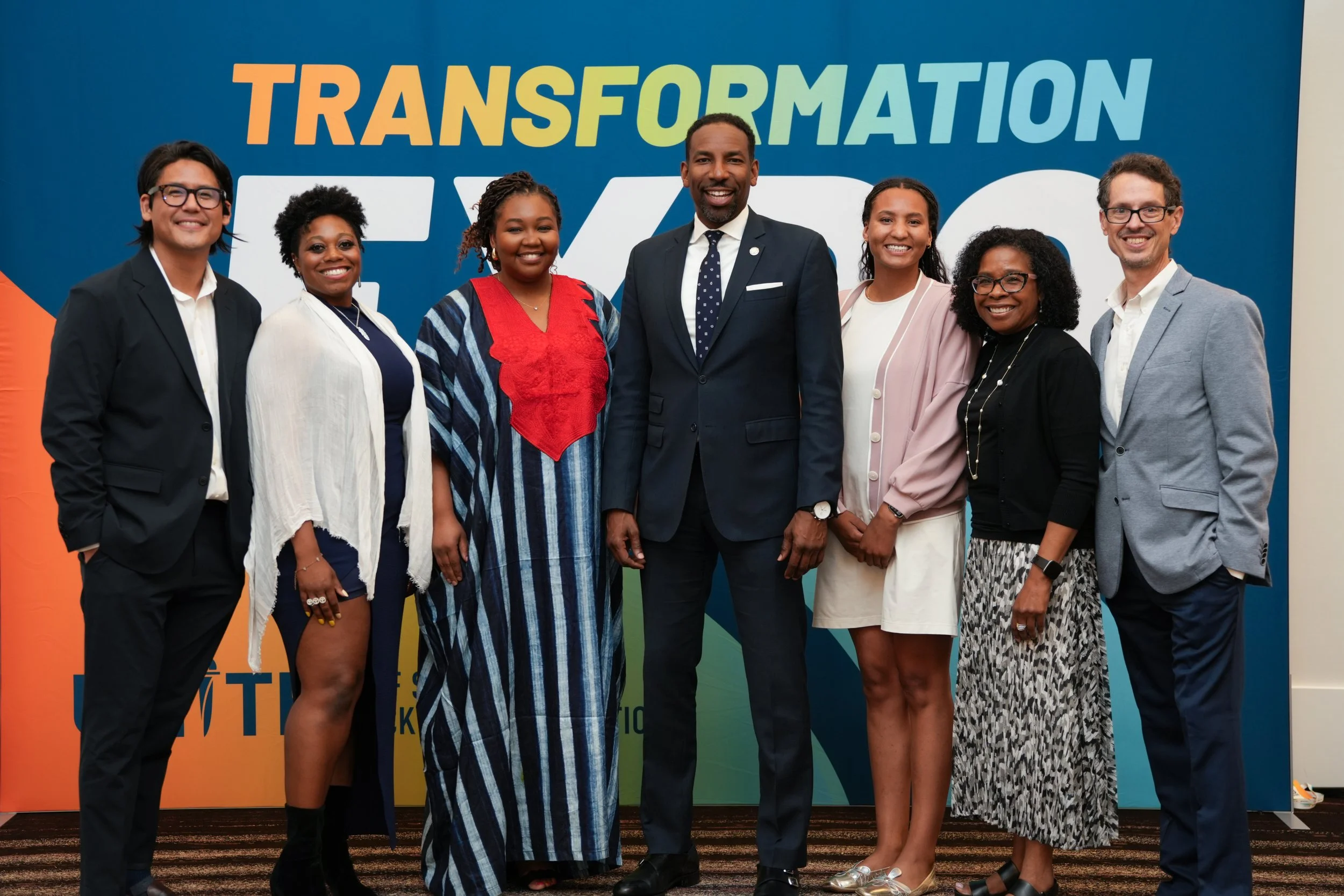 Attendees posing together at corporate networking mixer