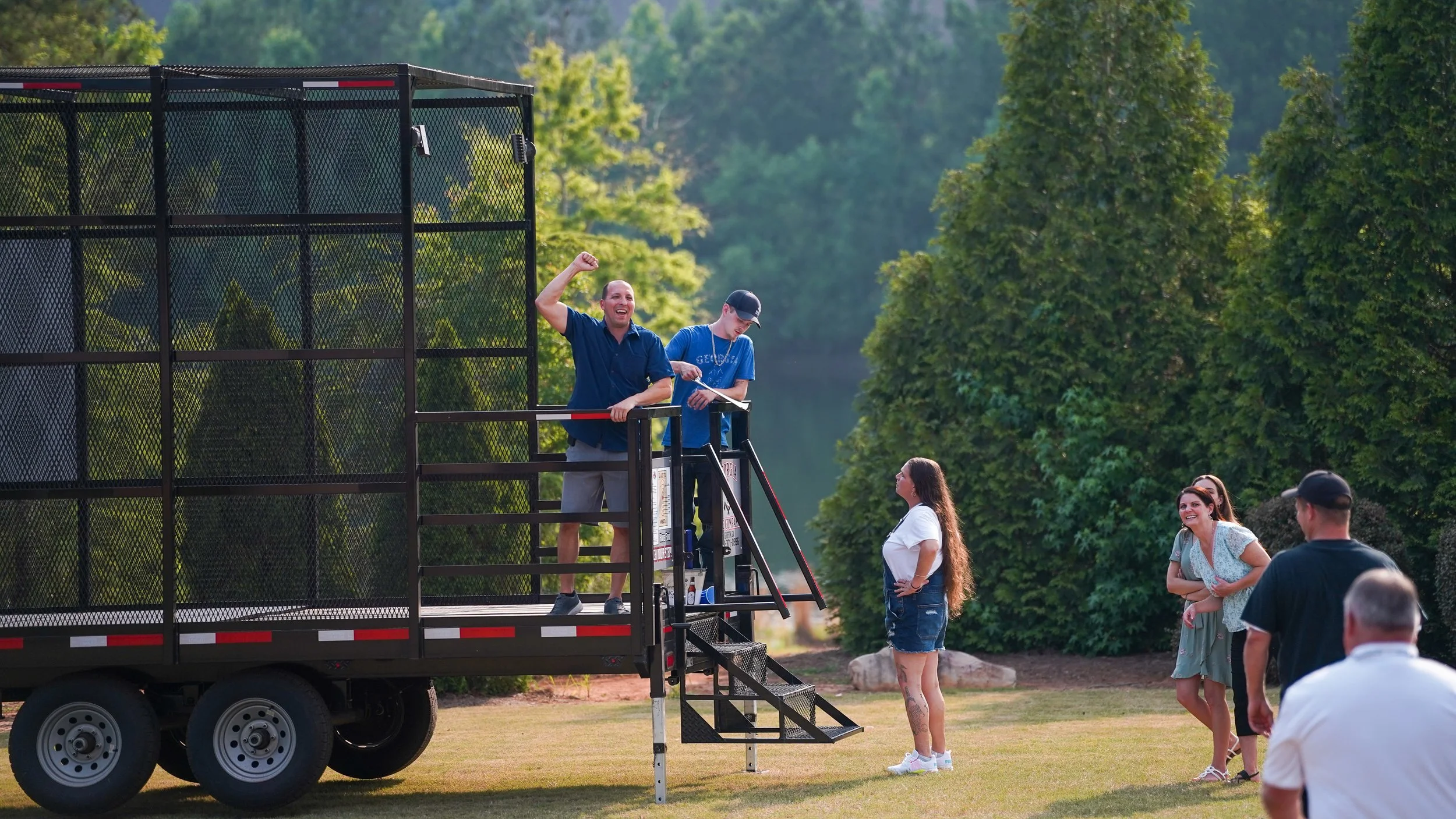 Outdoor axe throwing event with participants competing on targets
