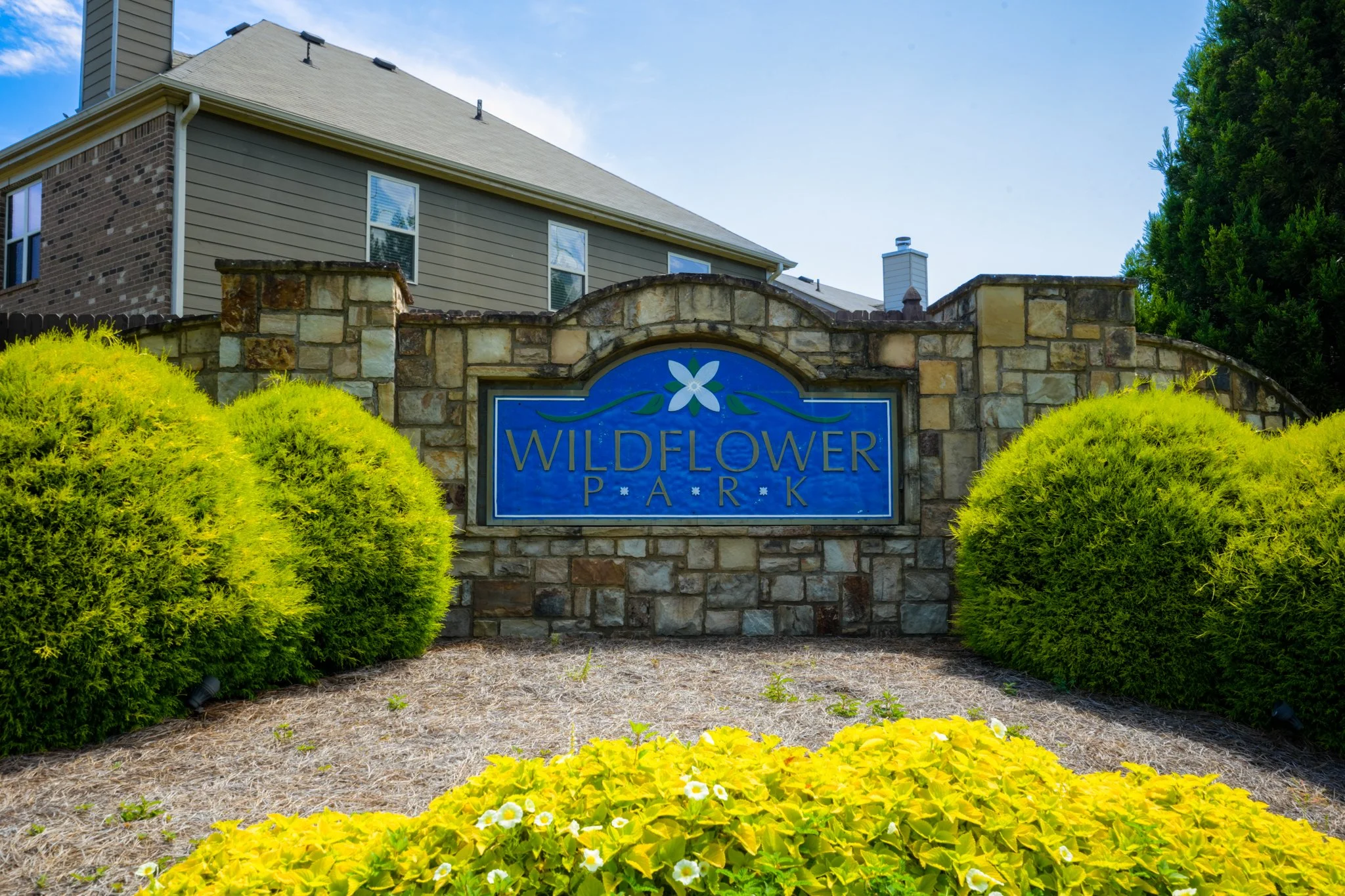 Community entrance sign photographed professionally for real estate marketing