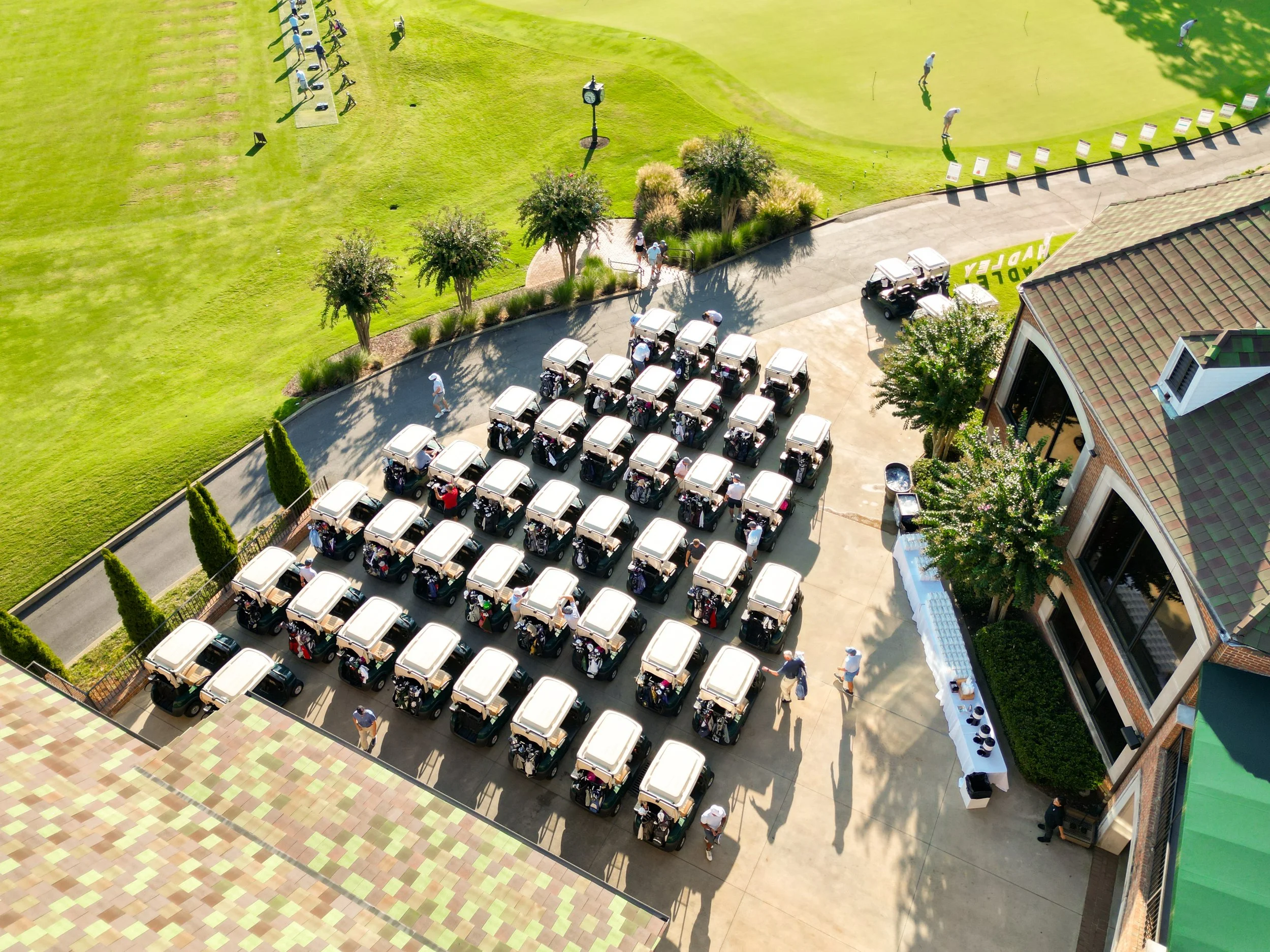 Aerial view of golf tournament with players and course layout