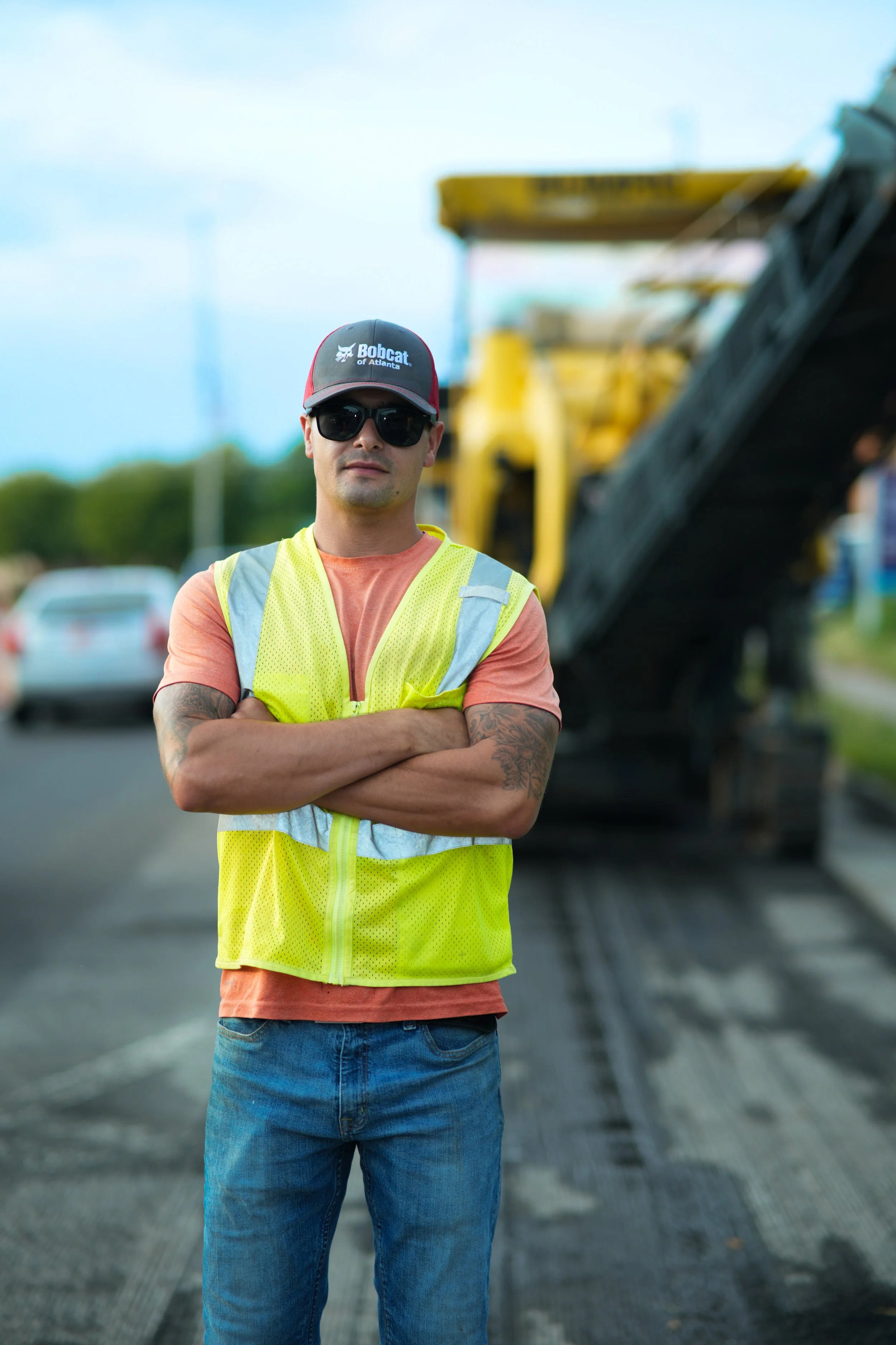 Workers using road construction equipment to improve streets