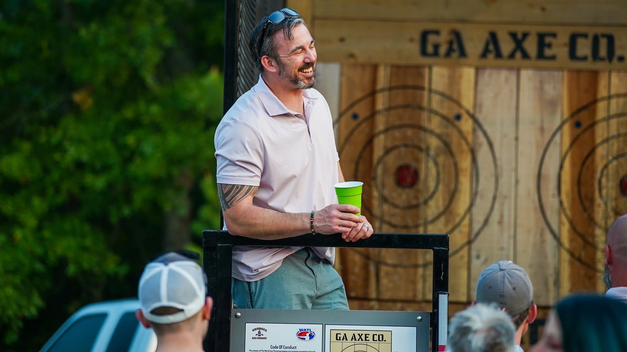 Group enjoying recreational axe throwing at outdoor event