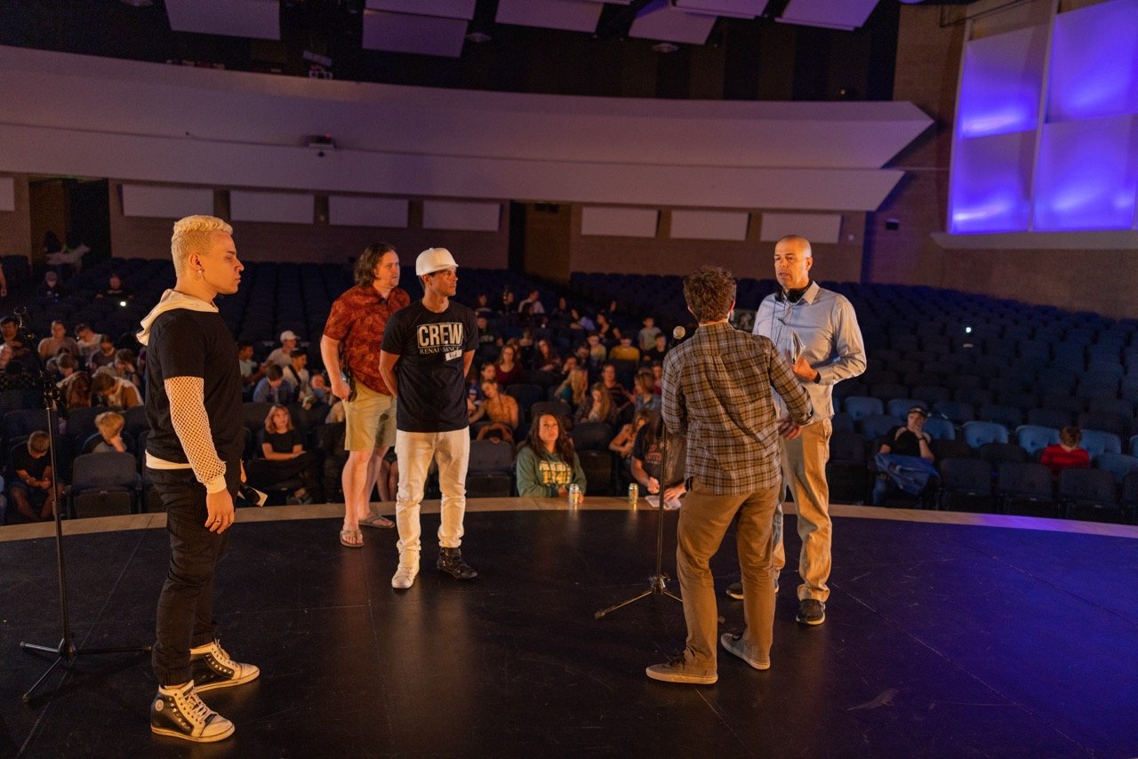 DP and AD watch as Director runs through a theatre stage scene.