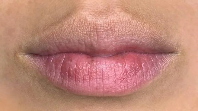 Close-up of human lips with a natural color and texture.