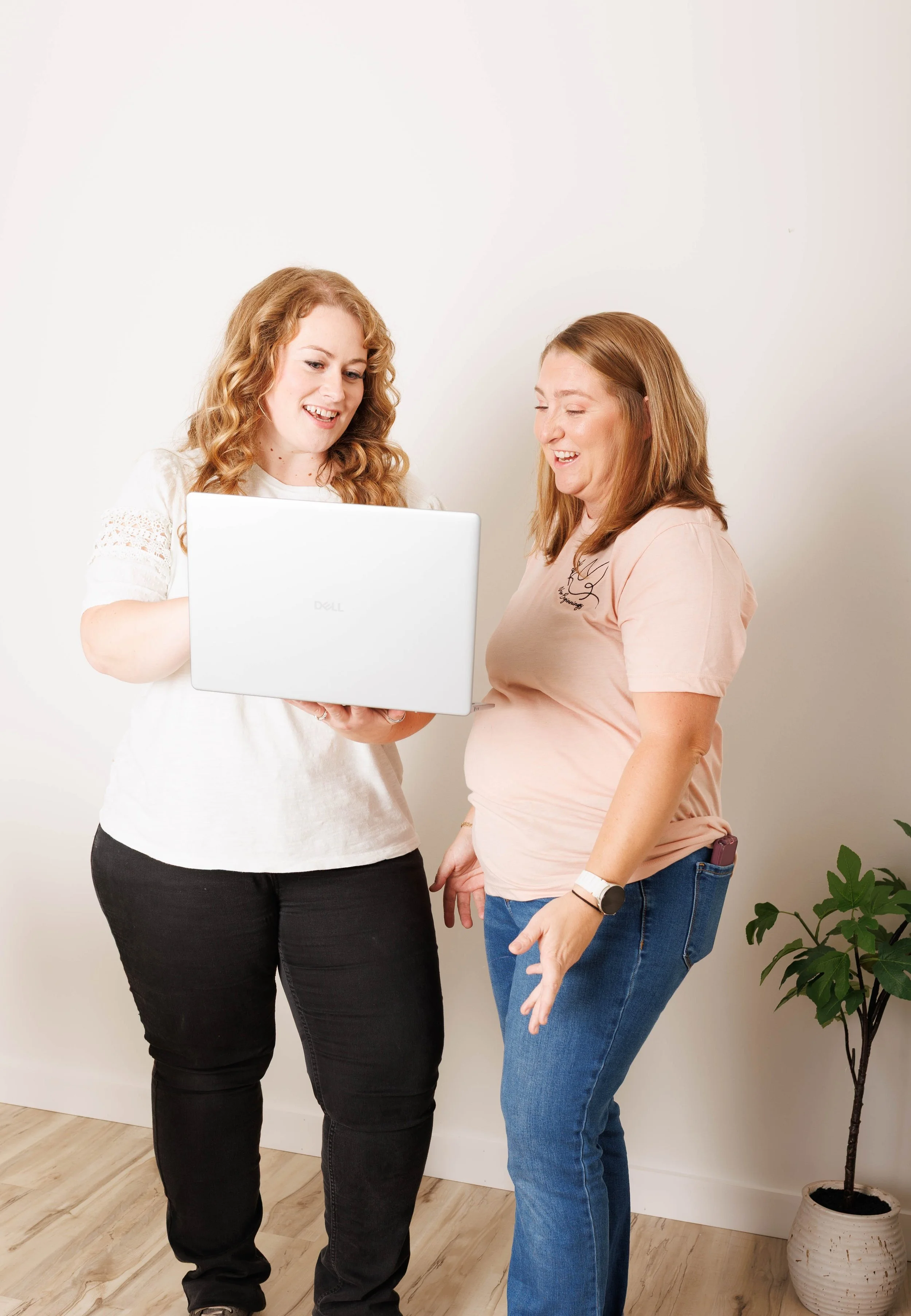 Natasha Bradt, Founder of 3 Lakes Bookkeeping, reviewing financial records on a laptop with a client, demonstrating the small business onboarding and accounting process.