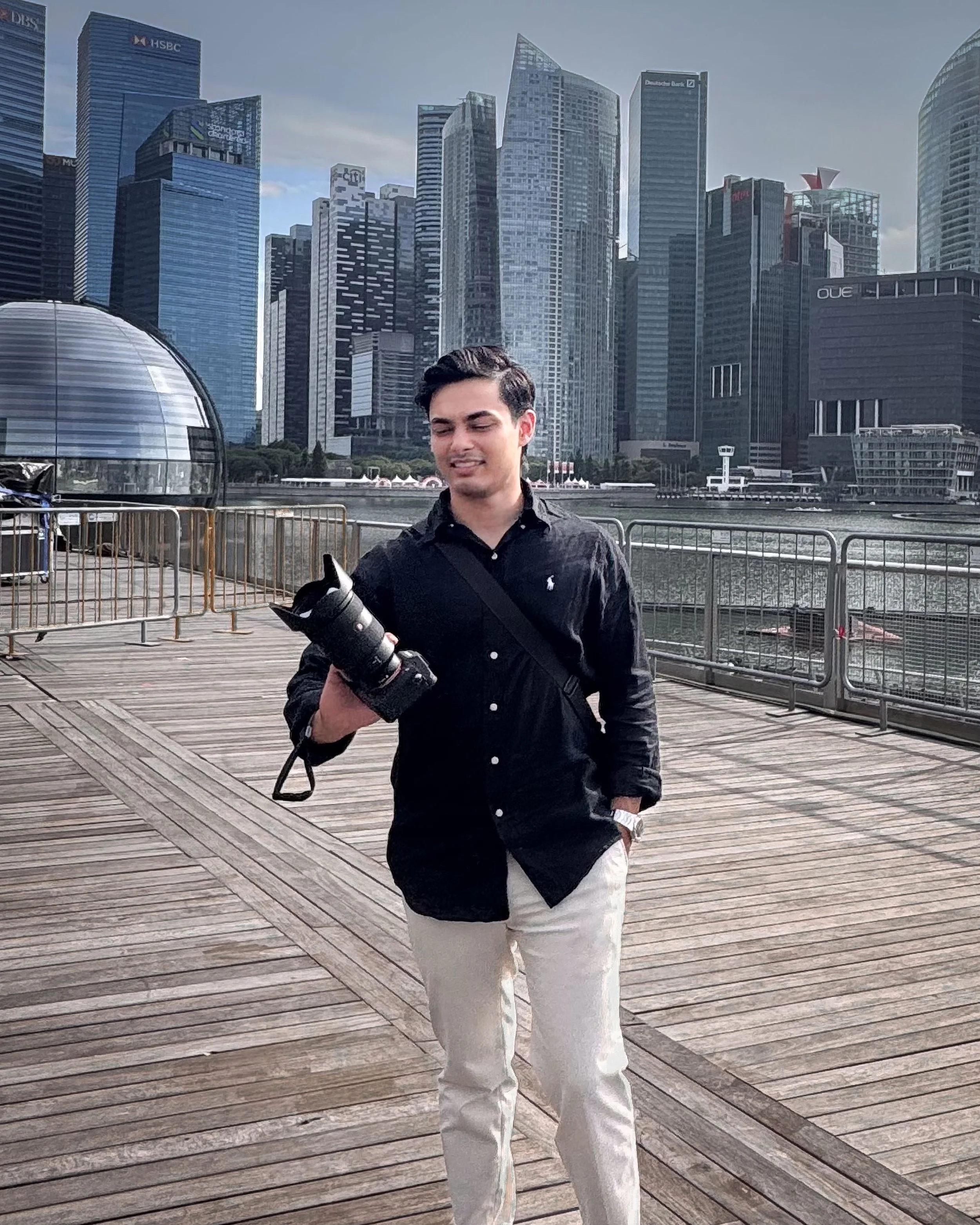 Photographer on boardwalk with city skyline - behind the scenes at Zen Captures, Sydney.