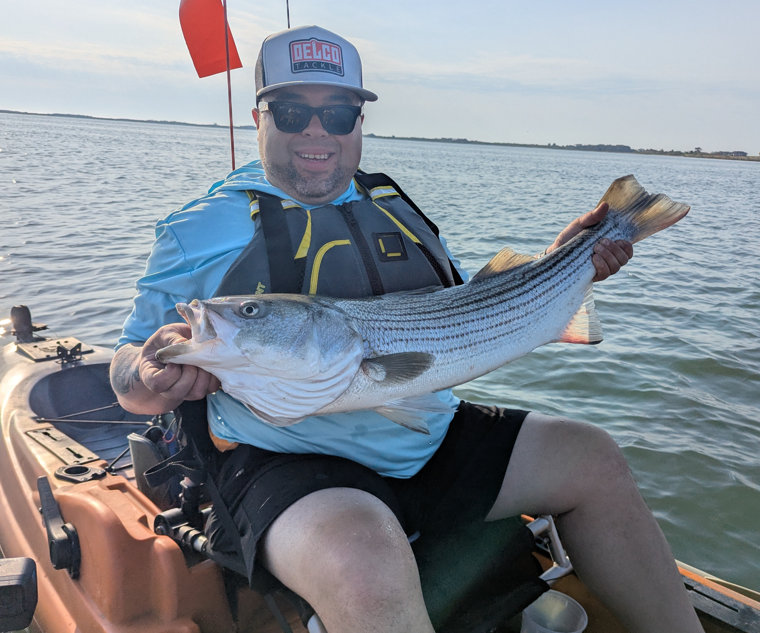 Client holding an over-slot striped bass. Nice job Lenny!