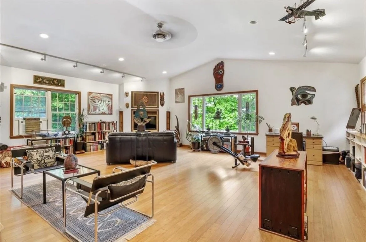 The main gallery area with large windows provides natural light, showcasing Nitin’s recent works.