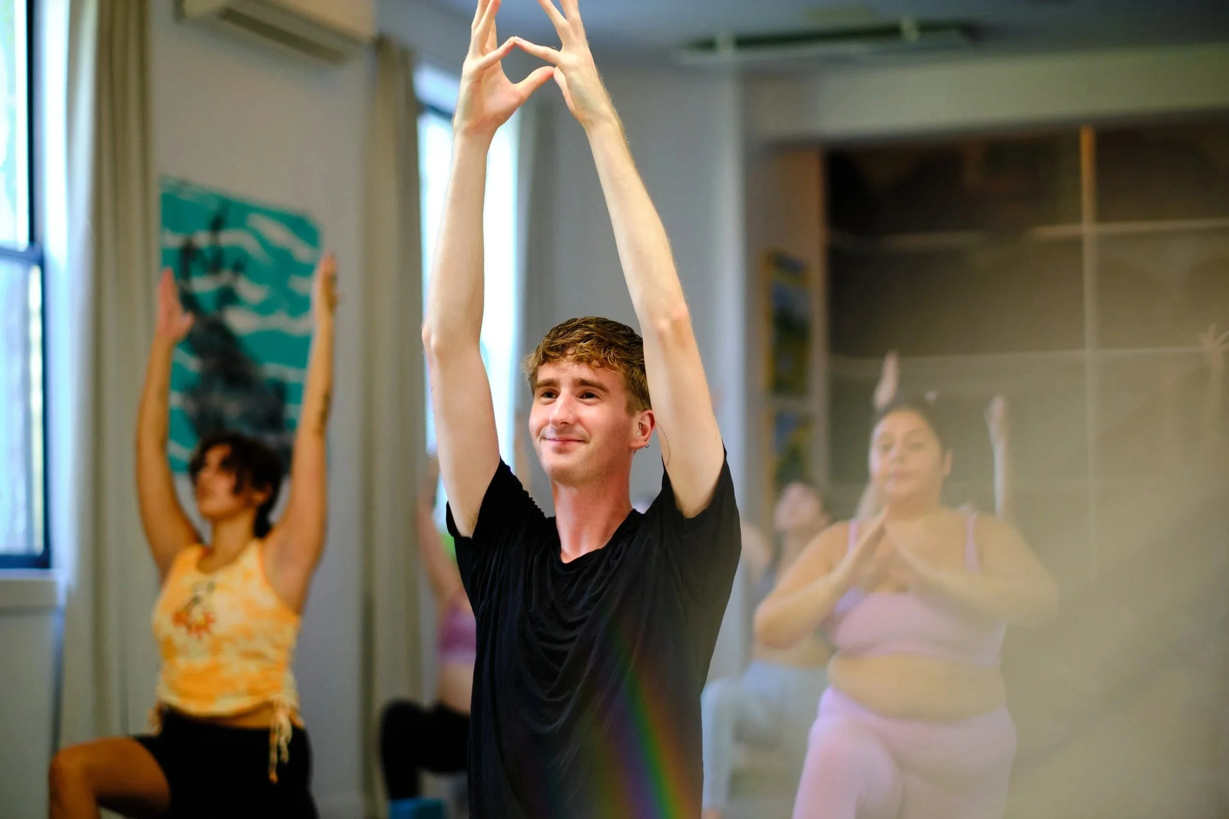 Private yoga instructor Jimmie Costello leading an anatomy-informed in-home session in NYC.