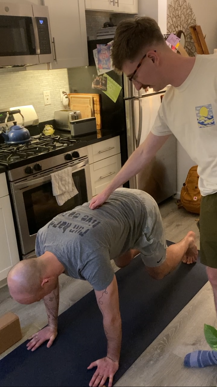 Jimmie Costello adjusting a client’s alignment to enhance core muscle activation and functional strength.