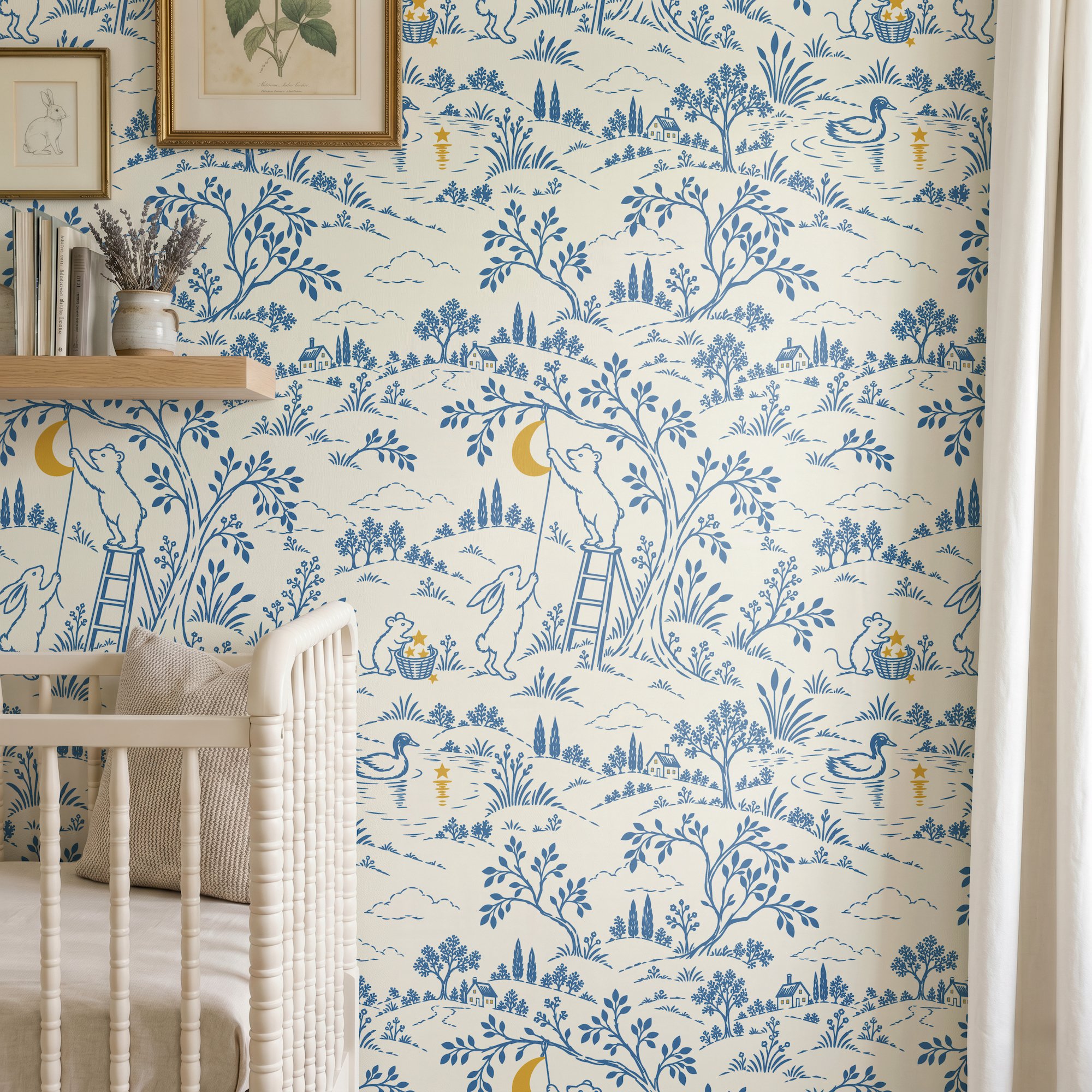 Blue and cream modern toile nursery wallpaper featuring woodland animals, a bear hanging the moon, rabbits, trees, and a scenic countryside from The Moon Garden collection by Ana Neagu Design.