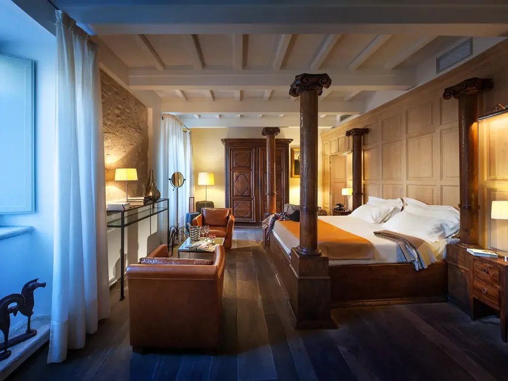 Luxurious bathroom with marble walls and floor, wooden vanity, glass shower, and bathtub.