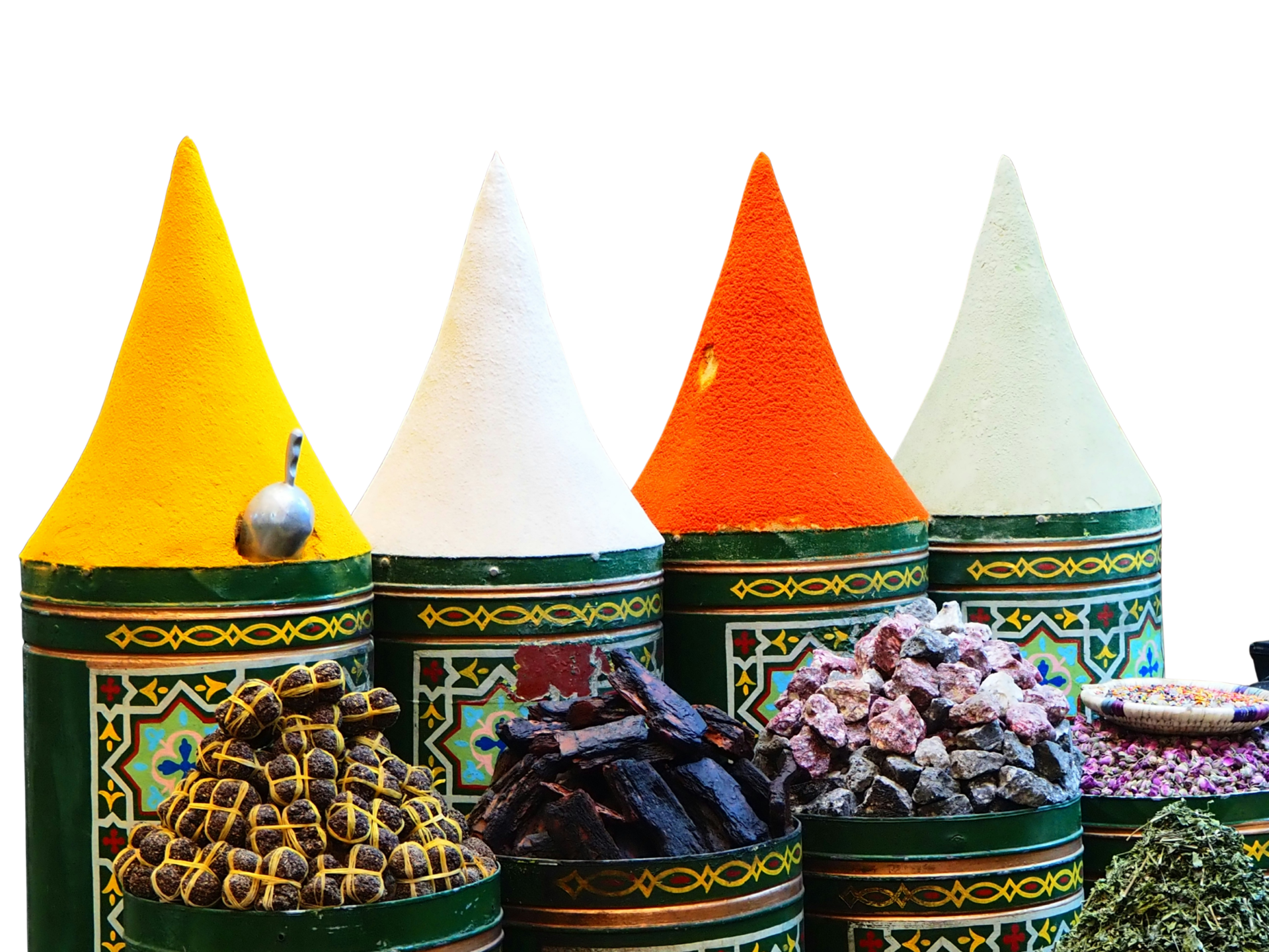Containers of colorful spices, including yellow, white, orange, and pale yellow powders, with dried herbs, rock salt, and other herbs in front, displayed on decorative green containers.