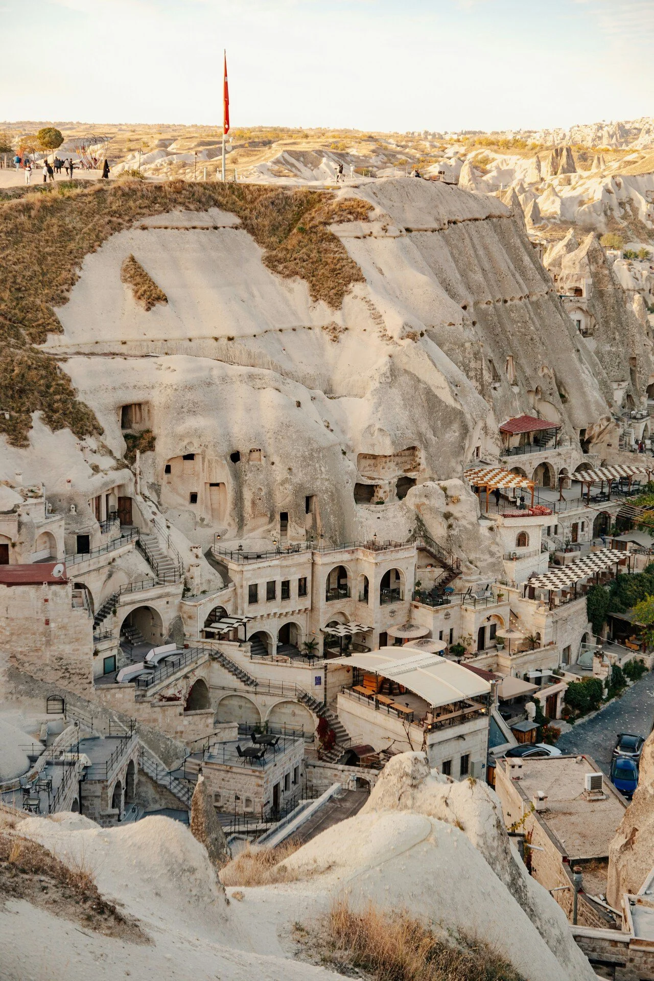 Rock formations and cave dwellings with shops and cafes built into the hillside.