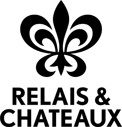 Silhouette of a person climbing a rock wall with a safety harness