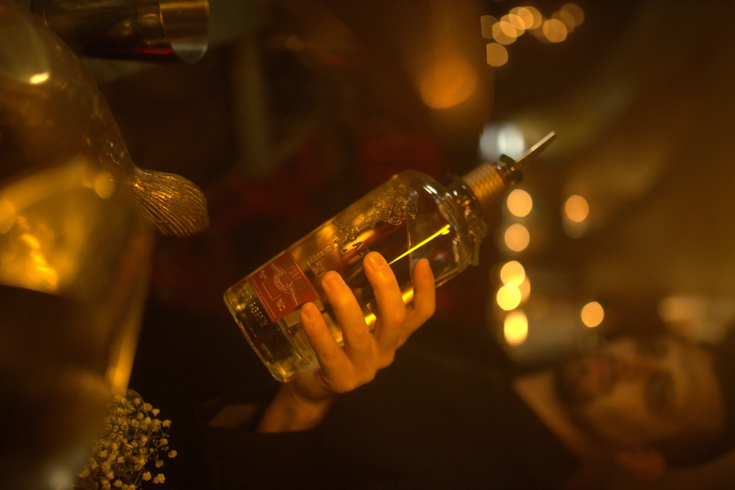 Professional bartender pouring premium Tesoro Azul Tequila during a high-end commercial hospitality brand activation managed by Lime Group Marketing