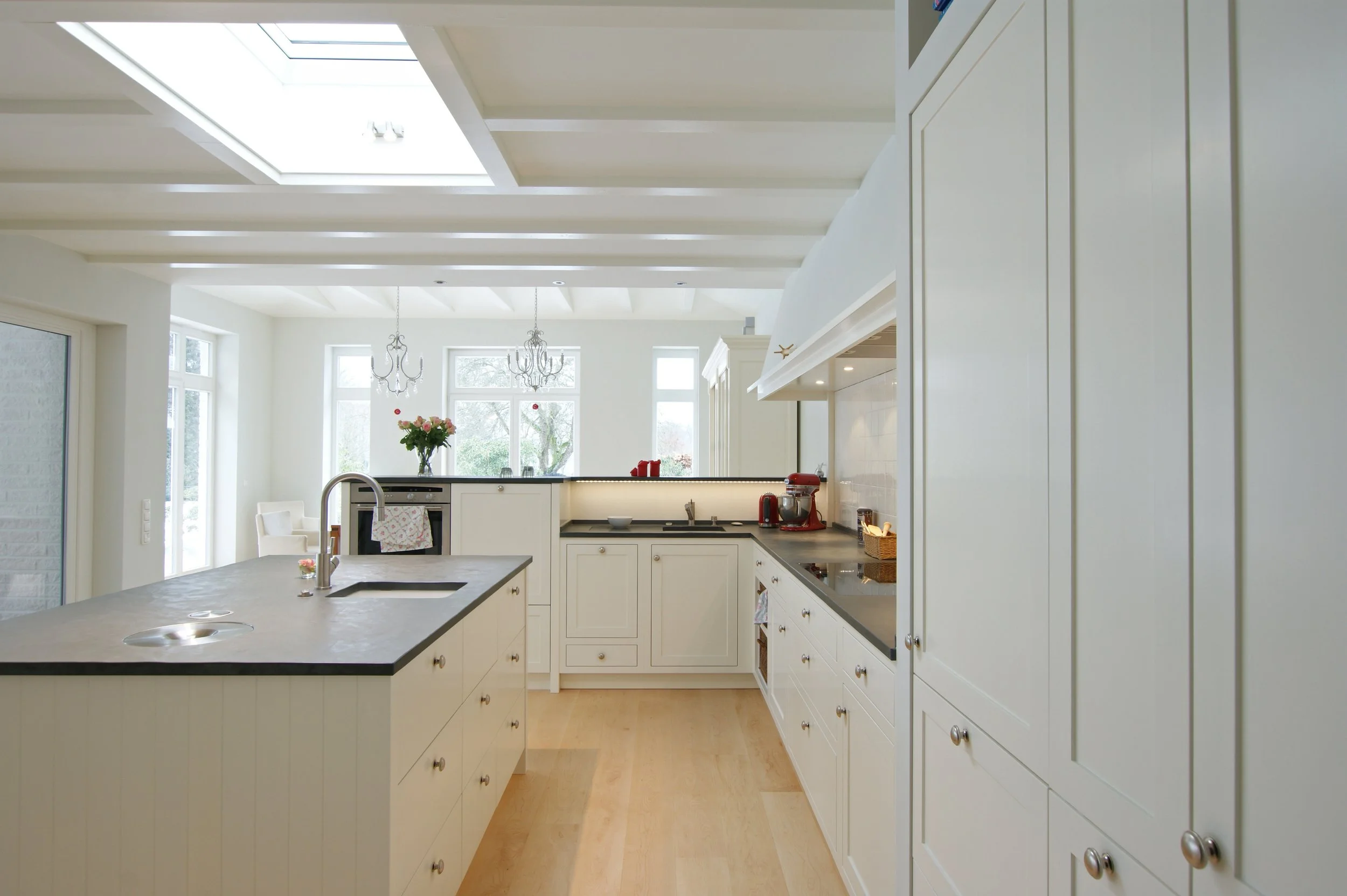 Weiße Landhausküche im Shaker-Stil mit dunkler Natursteinarbeitsplatte