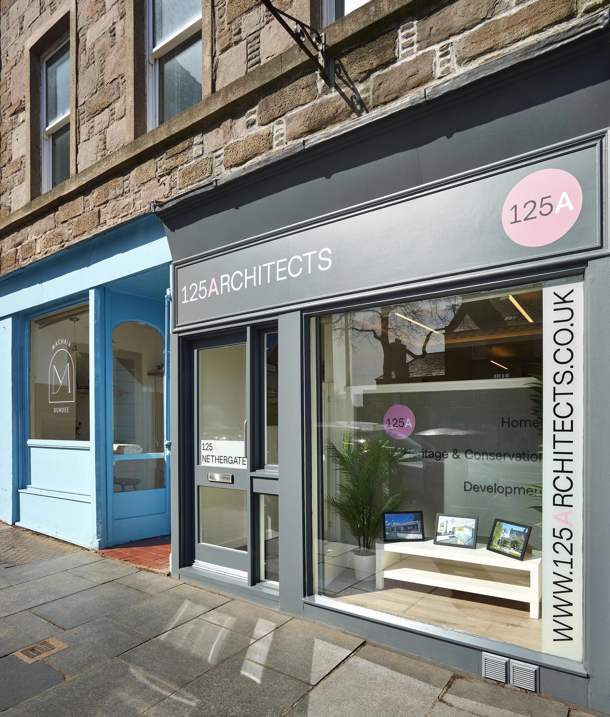 Exterior of 125A Nethergate, the Dundee studio of 125Architects, showing the grey shopfront, pink 125A signage and window display.
