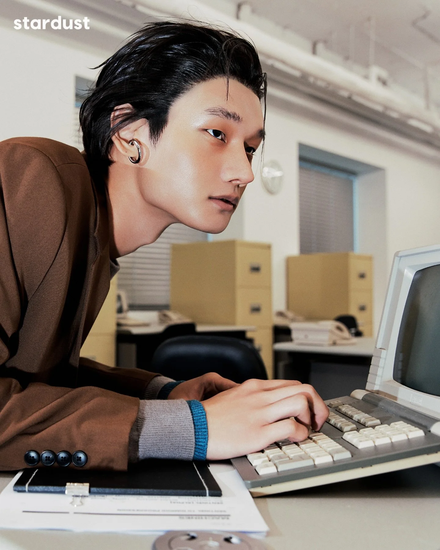 Young Blood follows a young worker pushed through the same tasks on repeat, caught between ambition and exhaustion. Crisp office styling, stacked paperwork, and small shifts in posture and expression chart the slide from focus into irritation, fatigu