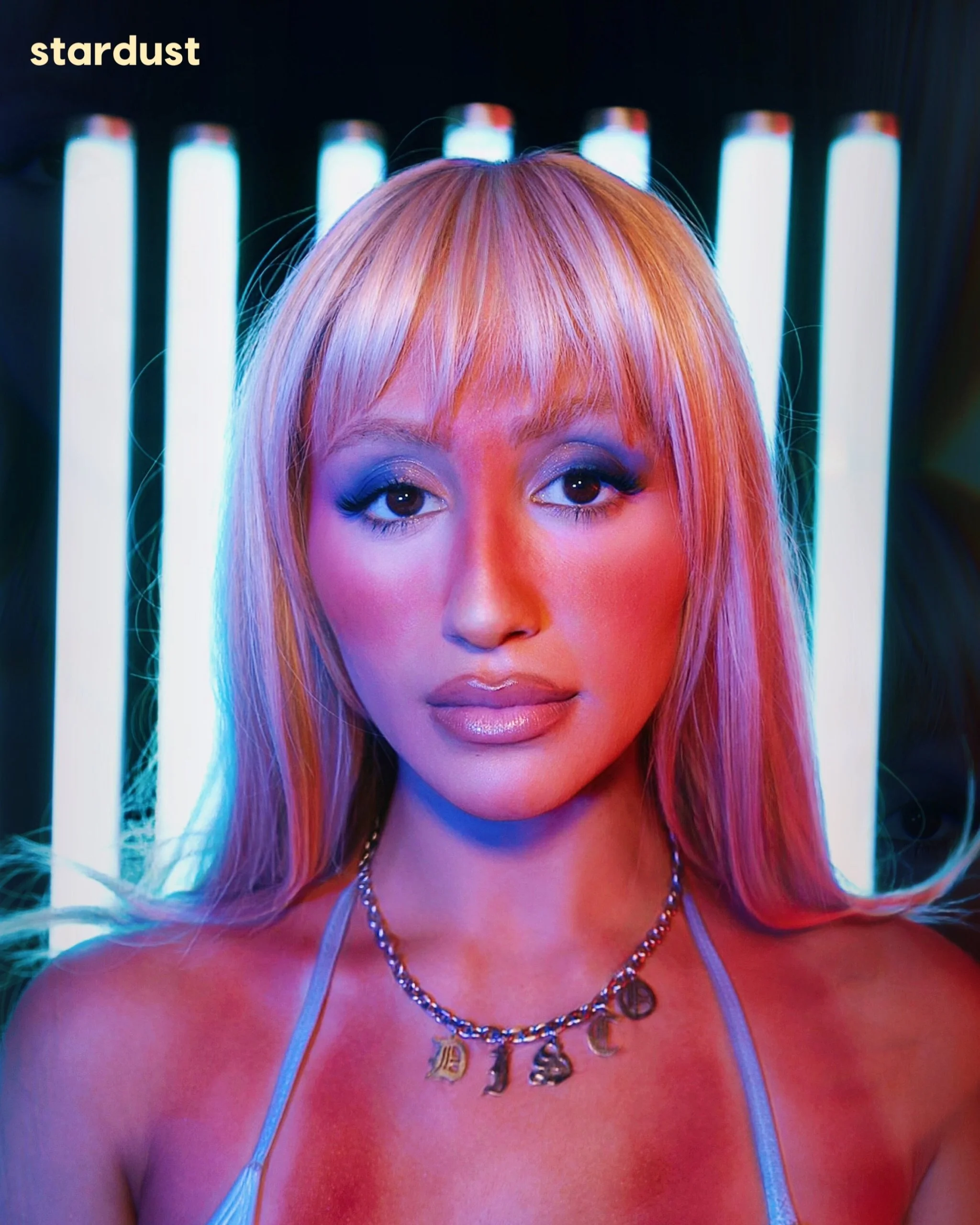 Disco Shrine (@discoshrine) is turning vanity, nightlife, and full-volume pop fantasy into her own kind of summer language. 

Now, for Stardust, the LA-based artist and DJ talks &ldquo;Spray Tan,&rdquo; the birth of #SprayTanSummer, merging hardstyle