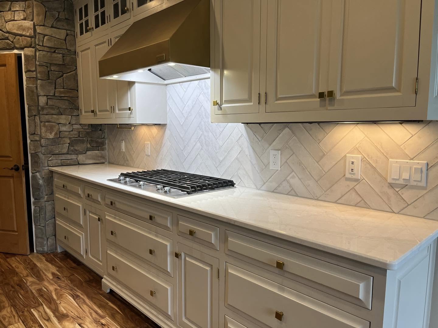 Complete kitchen remodeling with custom cabinetry, countertops, tile backsplash, and modern finishes. Residential kitchen renovation featuring new cabinets, countertops, backsplash tile, plumbing fixtures, and flooring.