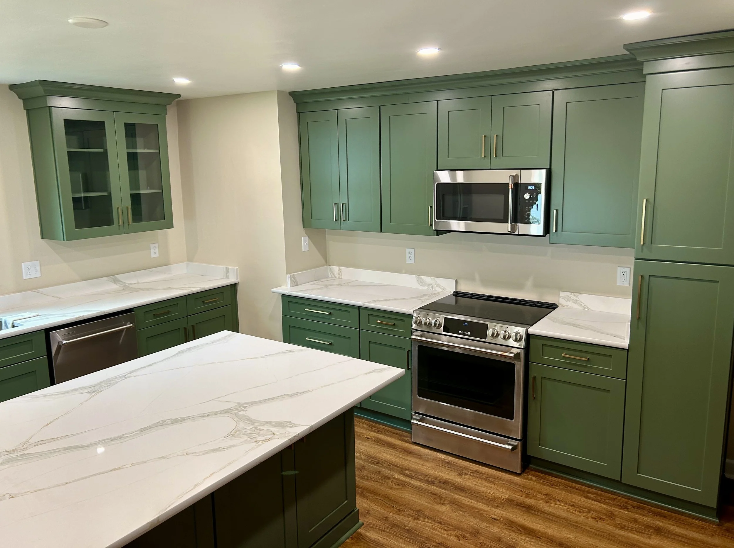 Complete kitchen remodeling with custom cabinetry, countertops, tile backsplash, and modern finishes. Residential kitchen renovation featuring new cabinets, countertops, backsplash tile, plumbing fixtures, and flooring.